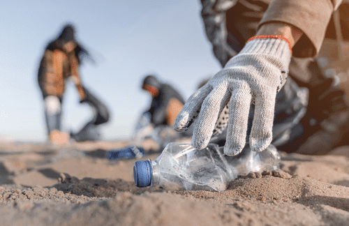 People picking up plastic litter on beach