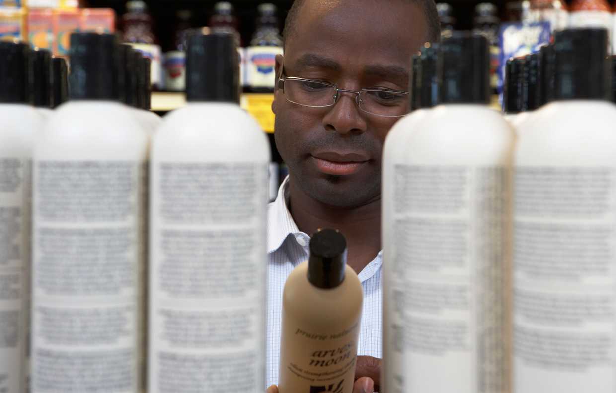 Man shopping for hair care products in store