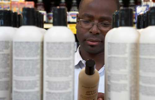 Man looking at hair care products in store